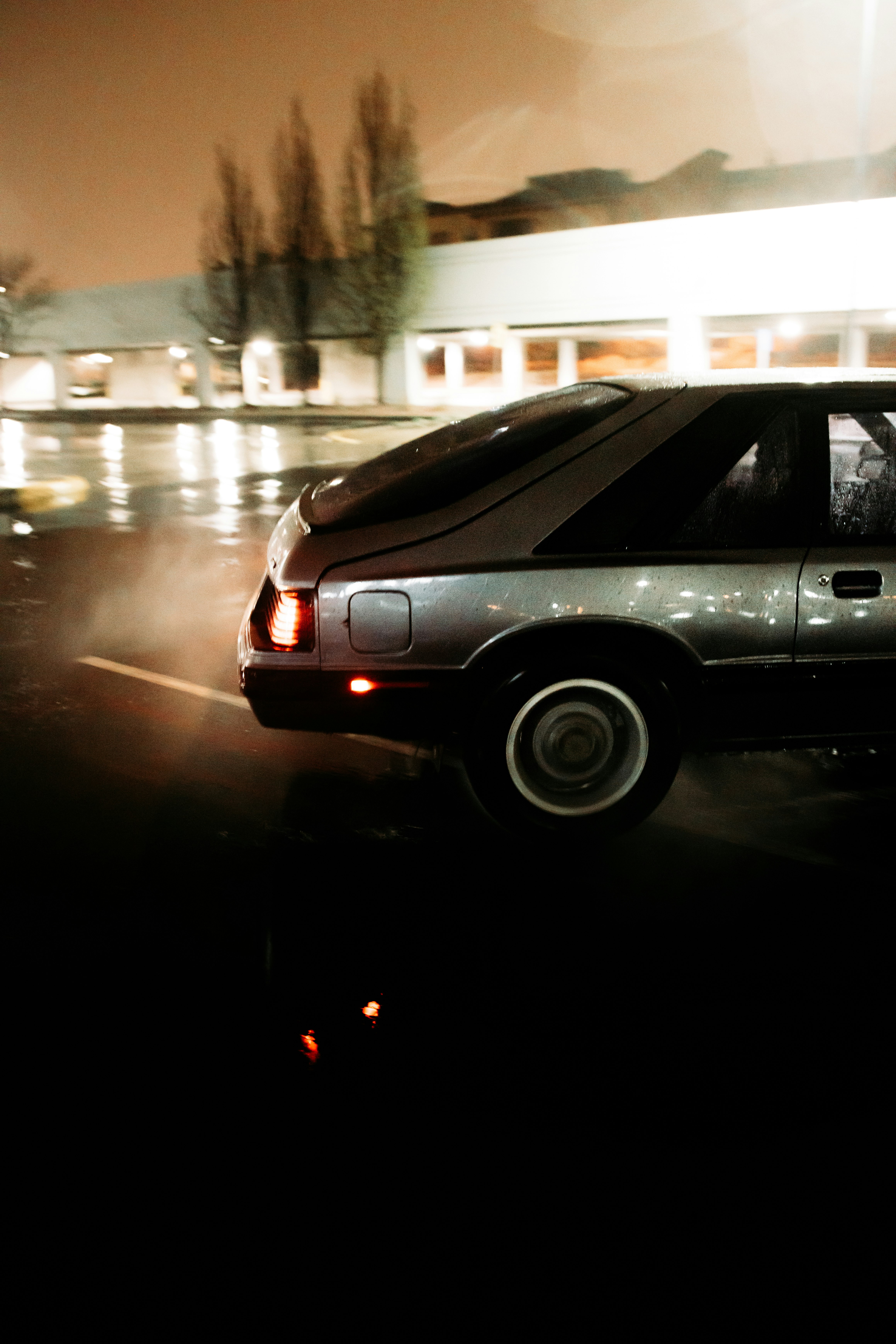 silver sedan on road during night time